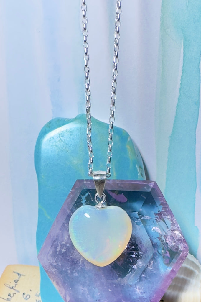 Australian opal pendant in a soft heart shape. Shows tones of green, yellow and pink, best displayed by slightly moving the opal about. Solid Australian Opal pendant.