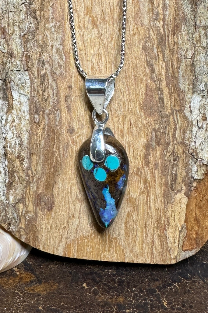 The opal has deep rivulets of very bright blue with green flashes and a sparkle of red. An Australian solid boulder opal pendant which has been inlaid with Arizona Turquoise. The pendant bail is silver Solid Australian Boulder Opal.