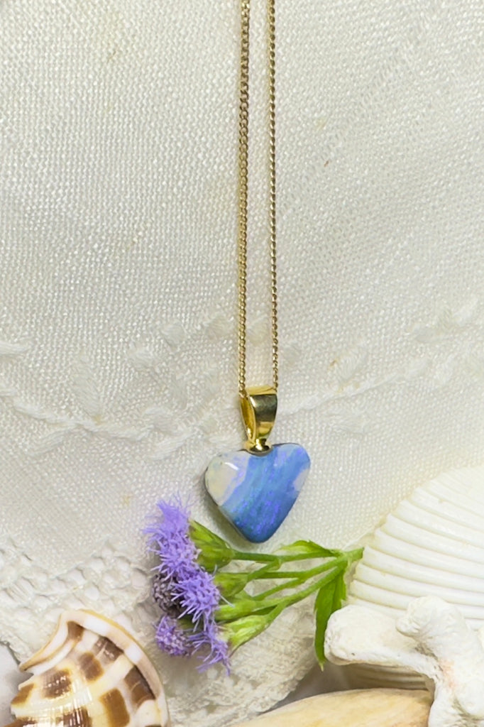 This Australian solid boulder opal pendant is cut into a heart shape. Clear crystal surface reveals the wonderful patterns beneath. The back of the heart is also polished.