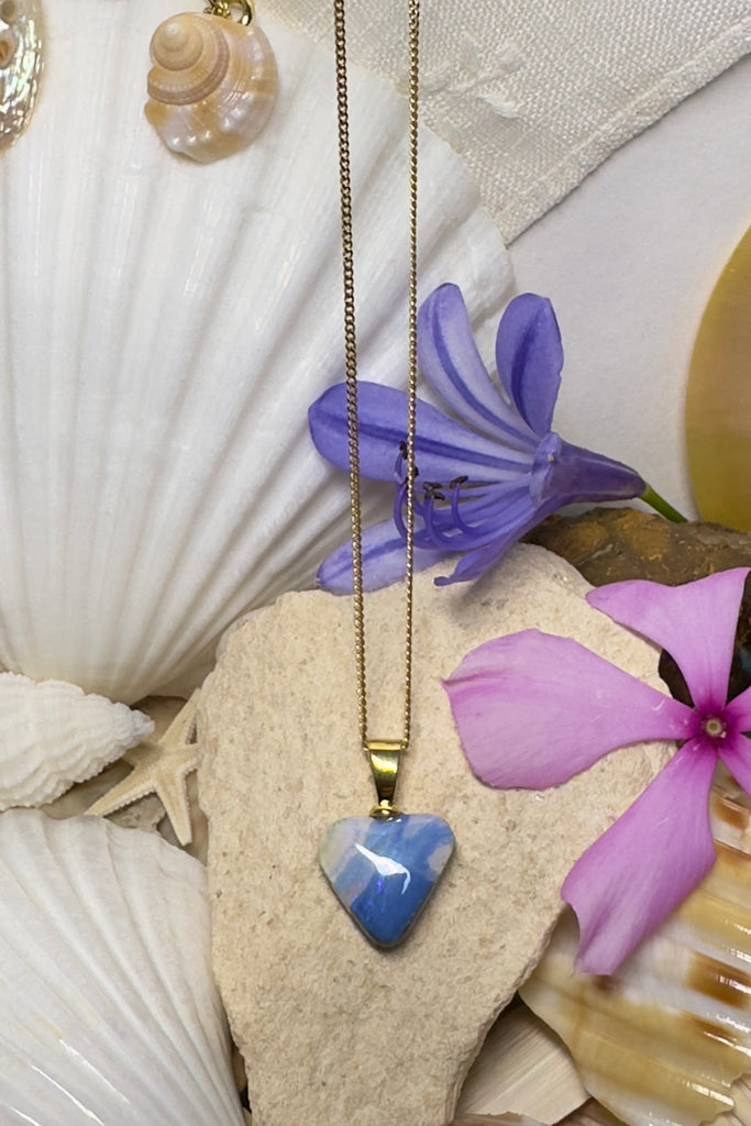 This Australian solid boulder opal pendant is cut into a heart shape. Clear crystal surface reveals the wonderful patterns beneath. The back of the heart is also polished.