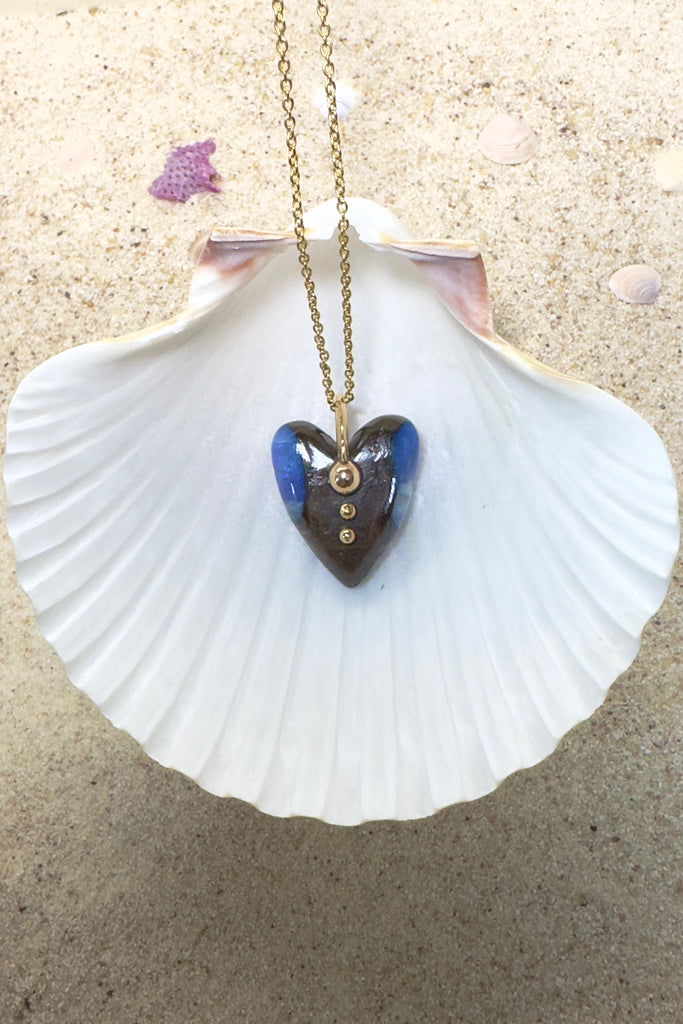 This is an absolute stunner, a lovely chunk of Australian opal carved into a heart the embellished with a repurposed 18ct gold earring being used as the bail.