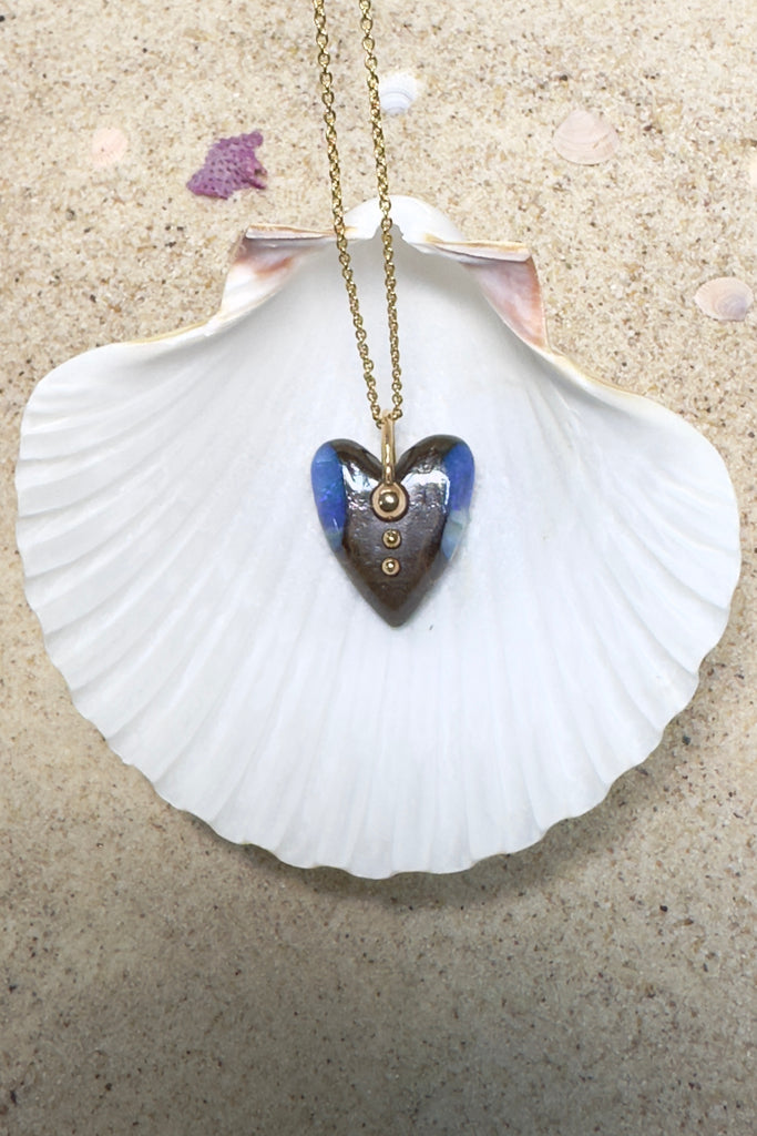 This is an absolute stunner, a lovely chunk of Australian opal carved into a heart the embellished with a repurposed 18ct gold earring being used as the bail.