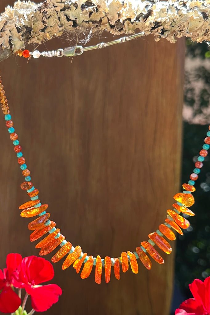 Necklace of glowing Baltic Amber set off with natural Turquoise beads, an interesting detail are the little Carnelian beads and the golden Citrine beads.

Gemstones are Natural Baltic Amber Baltic Amber purchased directly from source.&nbsp;
Natural Turquoise, Carnelian and Citrine.