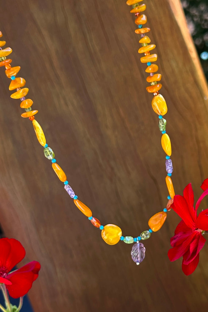 Necklace of glowing Baltic Amber in various shapes, the gentle colours of Amber and Peridot give an unusual modern twist to this ancient material.

Natural Baltic Amber Baltic Amber purchased directly from source.&nbsp;
Natural Amethyst, Peridot, Turquoise, Carnelian and Citrine.