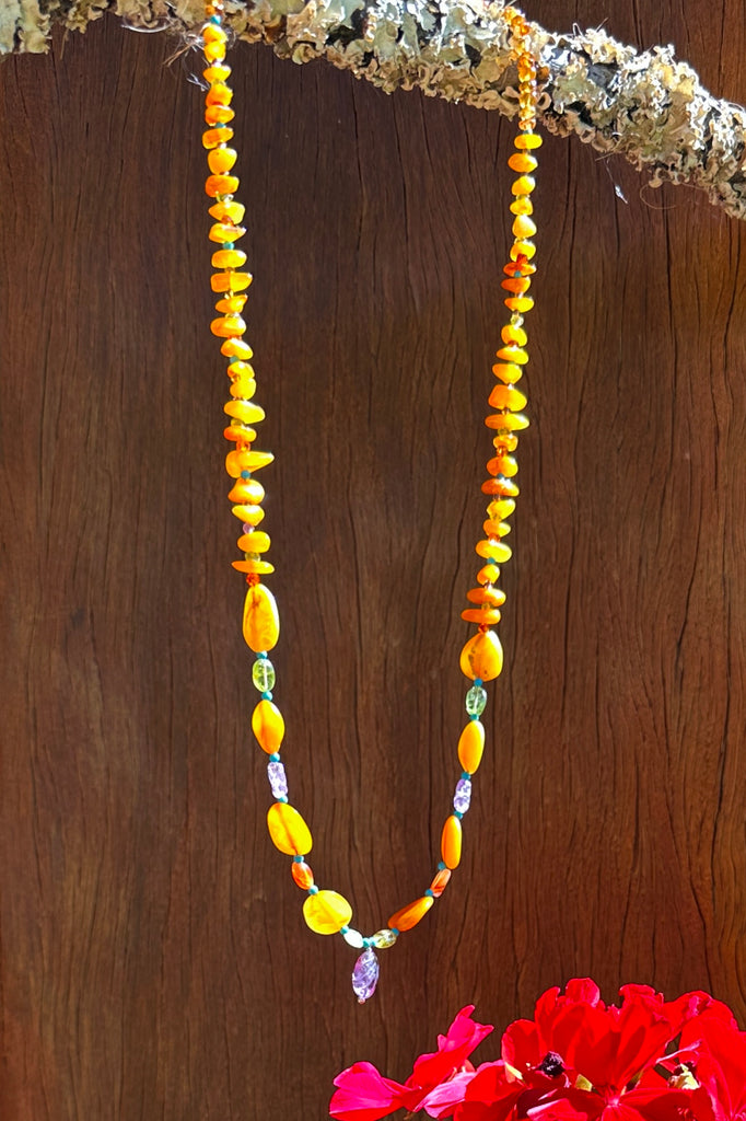 Necklace of glowing Baltic Amber in various shapes, the gentle colours of Amber and Peridot give an unusual modern twist to this ancient material.

Natural Baltic Amber Baltic Amber purchased directly from source.&nbsp;
Natural Amethyst, Peridot, Turquoise, Carnelian and Citrine.