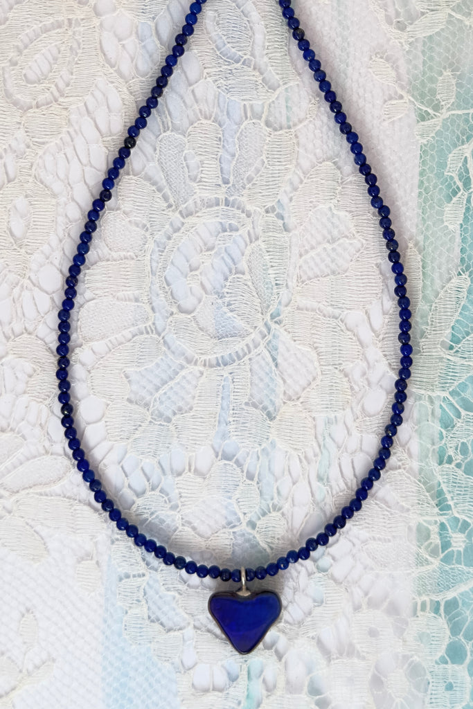 So chic, a bright splash of cobalt blue, solid boulder opal cut into a tiny heart it hangs from a deep blue Lapis Lazuli tiny bead necklace. 