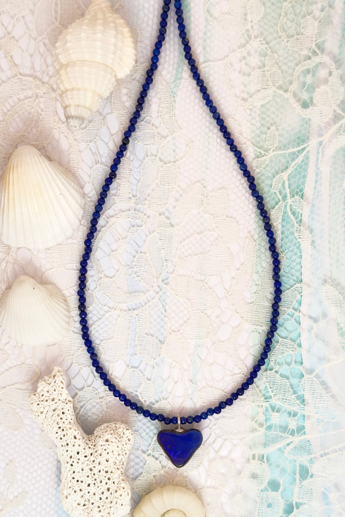 So chic, a bright splash of cobalt blue, solid boulder opal cut into a tiny heart it hangs from a deep blue Lapis Lazuli tiny bead necklace. 