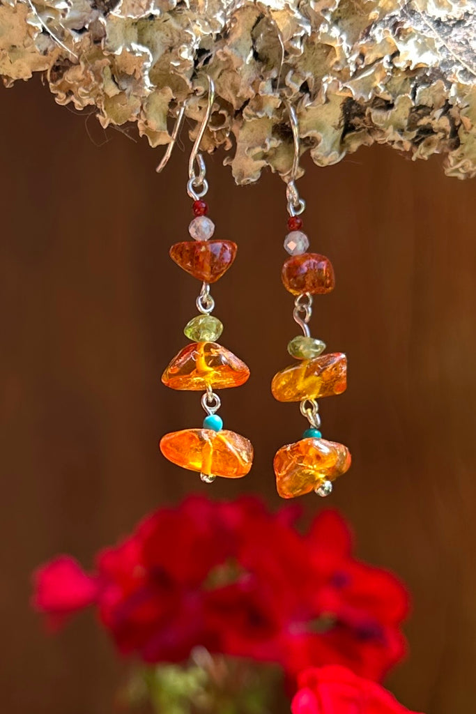 Baltic Amber earrings that dance in the sunlight or in the firelight on a winters evening.

Natural Baltic Amber.
Turquoise, Peridot and Garnet tiny beads.