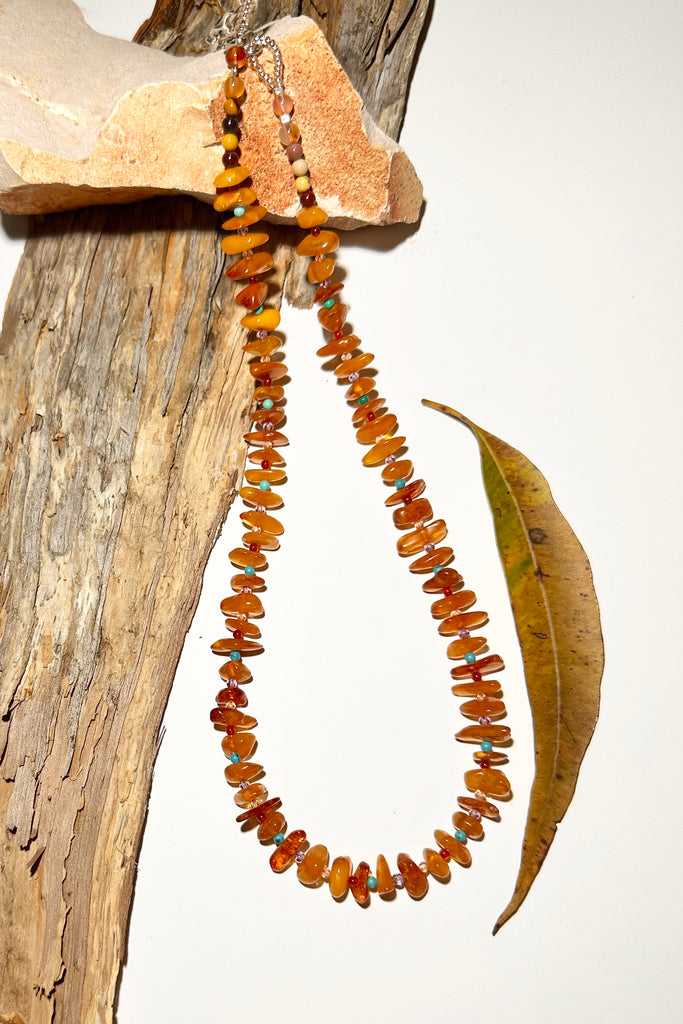 Necklace of glowing Baltic Amber in various flat shapes interspaced with tiny round beads of assorted gemstone beads. A bright and cheerful amber necklace for everyday.

Vintage Natural Baltic Amber Baltic Amber purchased directly from source.