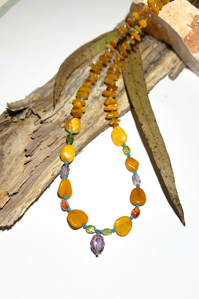 Necklace of glowing Baltic Amber in various shapes, the gentle colours of Amber and Peridot give an unusual modern twist to this ancient material.

Natural Baltic Amber Baltic Amber purchased directly from source.&nbsp;
Natural Amethyst, Peridot, Turquoise, Carnelian and Citrine.