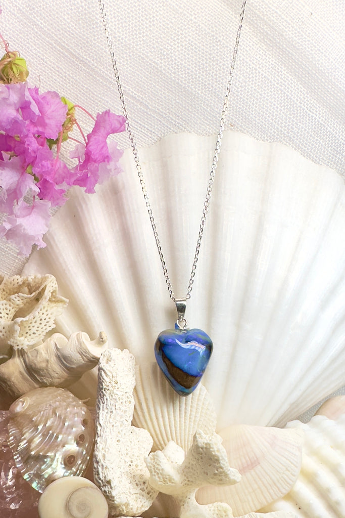 Tiny but eye catching, this Australian Opal heart pendant has unique and intriguing bright blue and misty blue patterns swirling up the stone.  