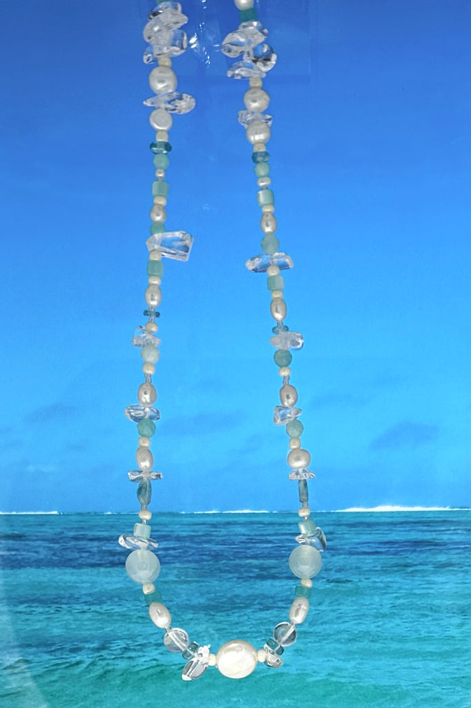 Perfectly luminescent pearls in a ocean splash of aqua and crystal, a pearl necklace that has the colours and the calm of the tropical island waters. A lucky coin pearl as the centrepiece.

Freshwater pearls in assorted sizes and colours.
Amazonite, Rock Crystal, Quartz, and Mother of pearl beads.