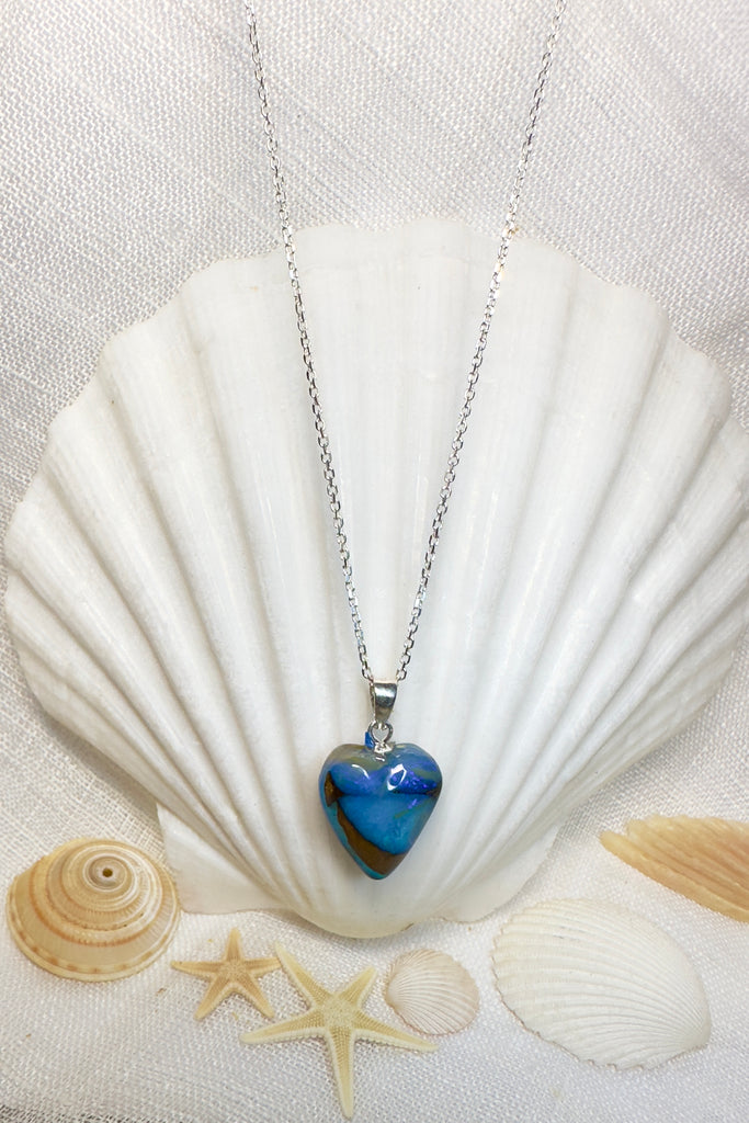 Tiny but eye catching, this Australian Opal heart pendant has unique and intriguing bright blue and misty blue patterns swirling up the stone.  