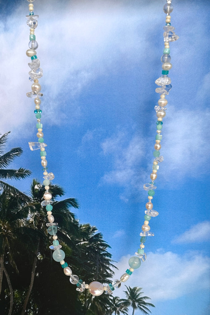 Perfectly luminescent pearls in a ocean splash of aqua and crystal, a pearl necklace that has the colours and the calm of the tropical island waters. A lucky coin pearl as the centrepiece.

Freshwater pearls in assorted sizes and colours.
Amazonite, Rock Crystal, Quartz, and Mother of pearl beads.