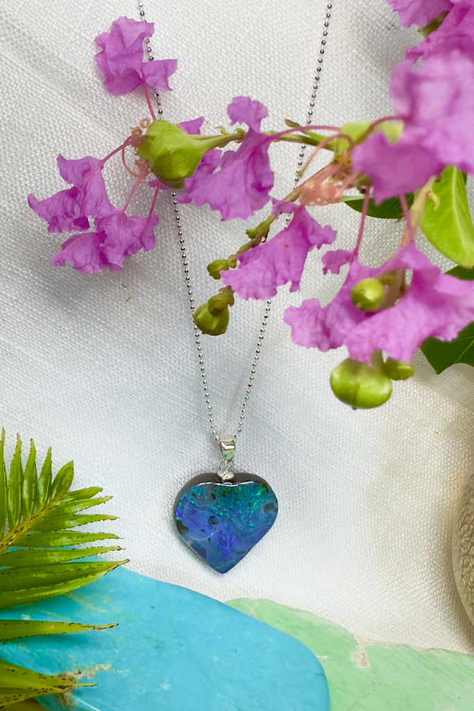 A gorgeous Australian boulder opal heart pendant, one could be looking at an ocean reef from above, deep blue sea and tiny islands.