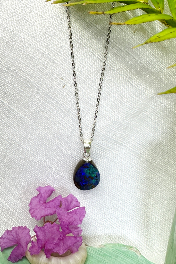 A tiny splash of deep blue and green on this subtle opal pendant one could be looking at an ocean reef from above, deep blue sea and tiny islands.