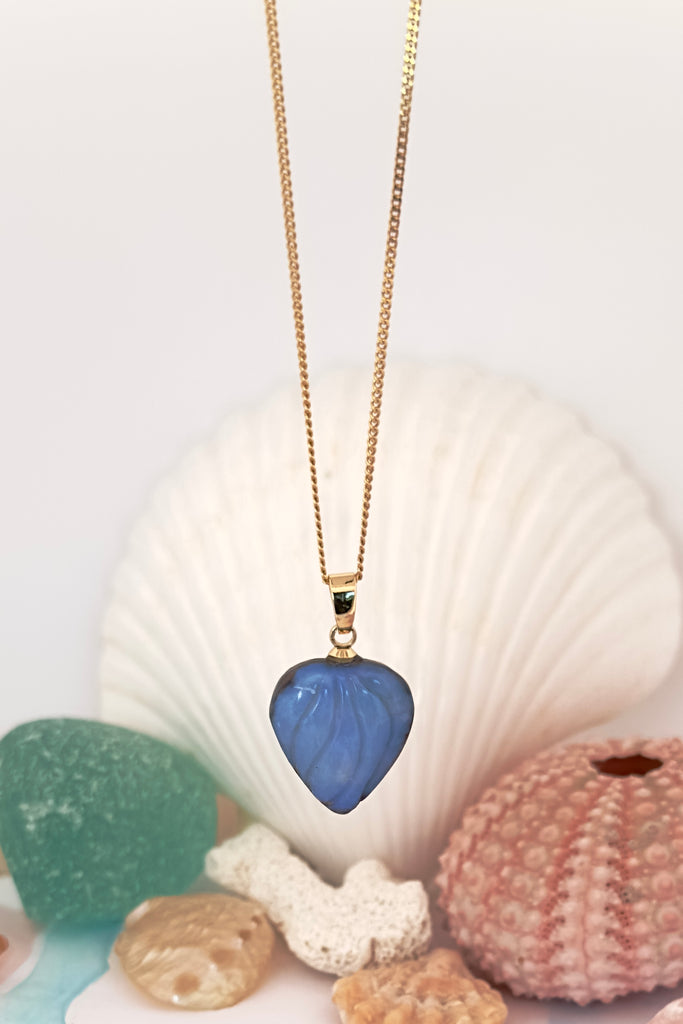 Carved into the opal are gentle  waves of water blue, our cutter has cleverly shaped it so that the shades of crystal blue swirl across in a watery wave pattern.