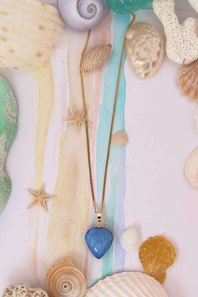 Carved into the opal are gentle  waves of water blue, our cutter has cleverly shaped it so that the shades of crystal blue swirl across in a watery wave pattern.