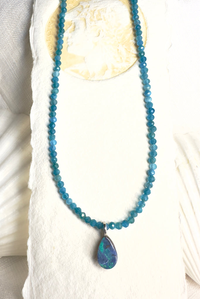 As cool as the sea on a summers day, this lovely opal is cut into a small droplet it hangs from a faceted Amazonite gemstone bead necklace that sparkles in the light.