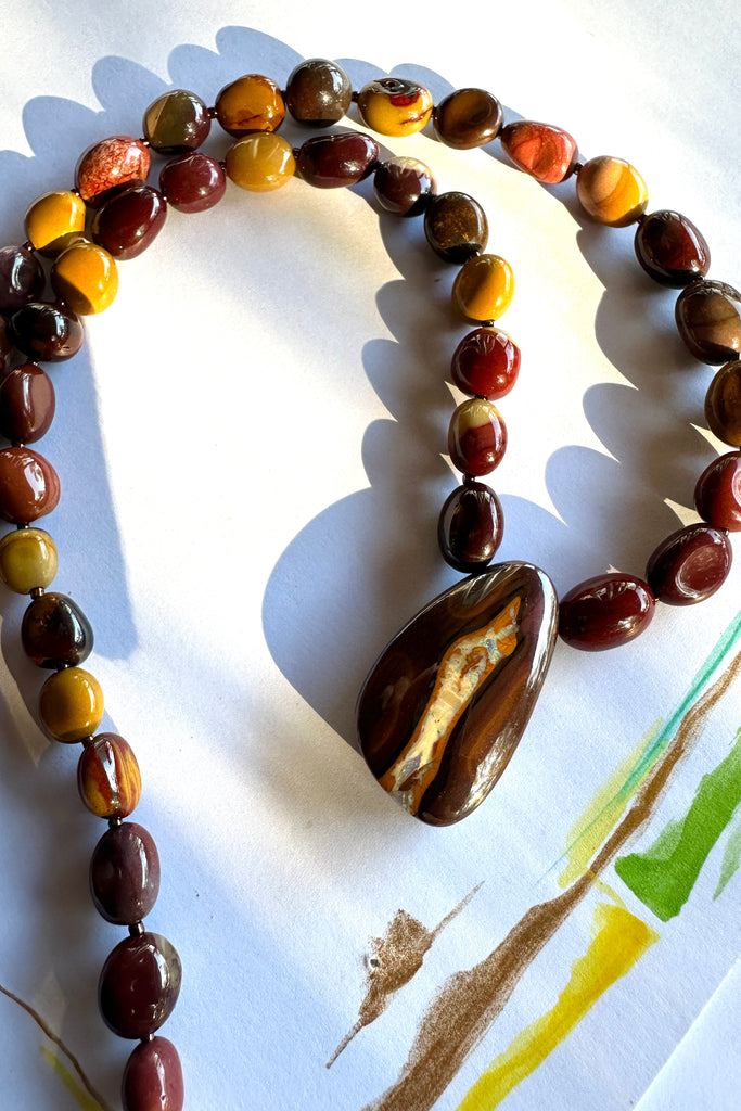 Solid Boulder Opal pendant on a necklace of Mookaite beads.
Opal has softly coloured crystalline drift down the centre.
Australian Mookaite stone beads found only in the Kennedy ranges of Western Australia.