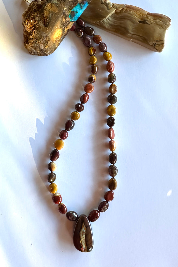 Solid Boulder Opal pendant on a necklace of Mookaite beads.
Opal has softly coloured crystalline drift down the centre.
Australian Mookaite stone beads found only in the Kennedy ranges of Western Australia.