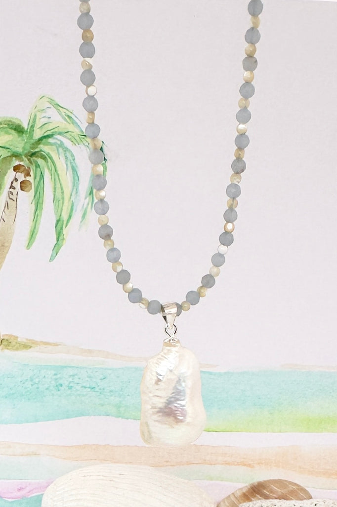 So pretty so romantic, this large Baroque pearl hangs off a necklace of tiny faceted blue Chalcedony beads, minimal with a touch of chic.