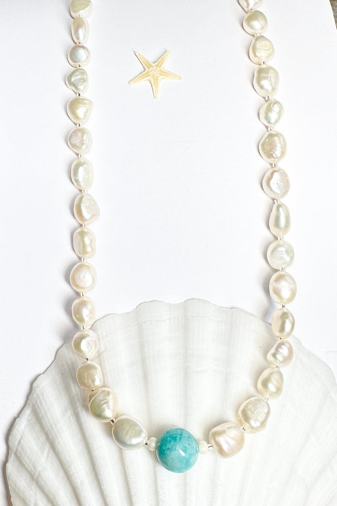 A necklace of creamy white pearls with a sea swirl of Amazonite bead as the centrepiece, perfect ocean inspired necklace