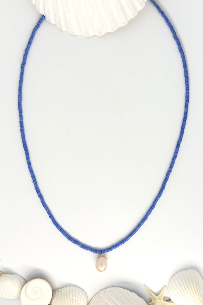 So pure so chic and modern, a lustrous drop pearl hangs from a necklace of sky blue seed beads.