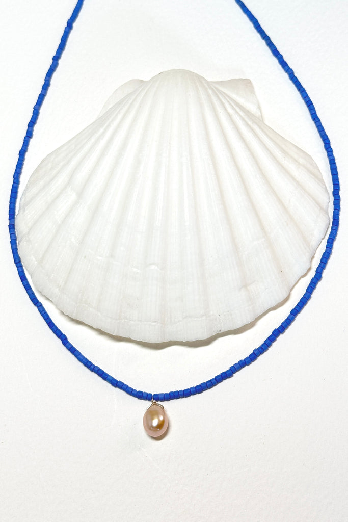 So pure so chic and modern, a lustrous drop pearl hangs from a necklace of sky blue seed beads.