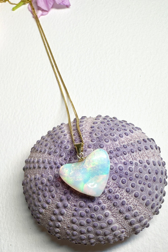 A lovely bright pastel coloured crystal opal heart pendant, very crystalline with tones of pink, apple green, and soft teal.