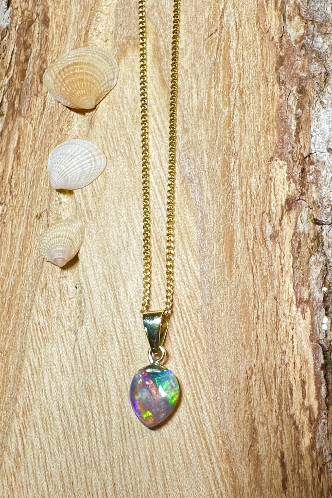 tiniest rainbow, this unique little drop of opal perfection has flashes of bright green, red, gold and blue across the stone. Absolute perfection in a small stone