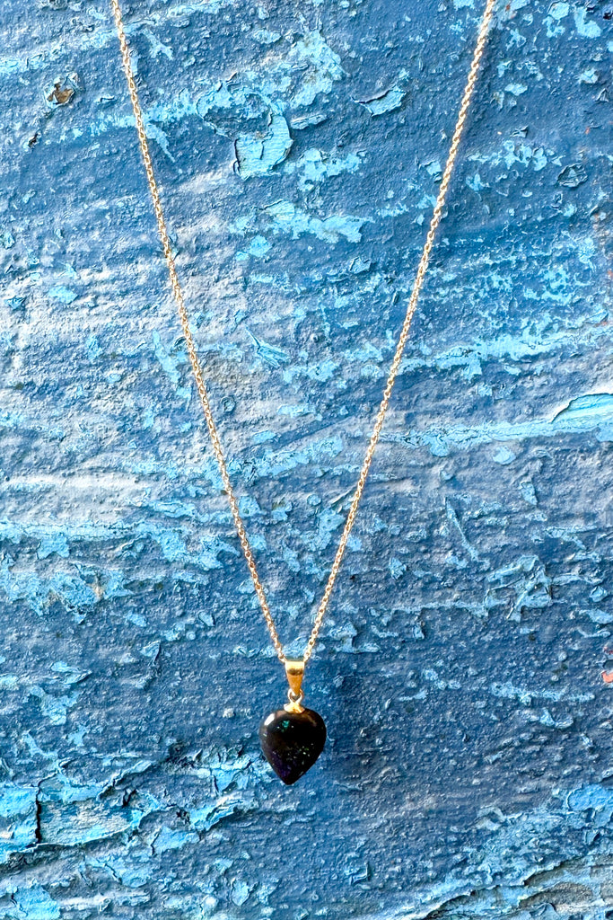 This Australian black opal pendant has bright blue and teal flash deep in the stone.