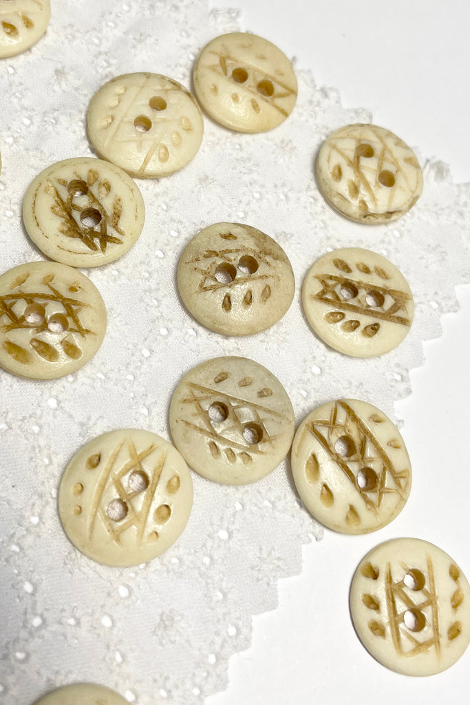 These quirky buttons are carved from bone in India, they are extremely unusual, the holes are all placed differently showing that these are indeed a "village" make, every pattern and button is different.