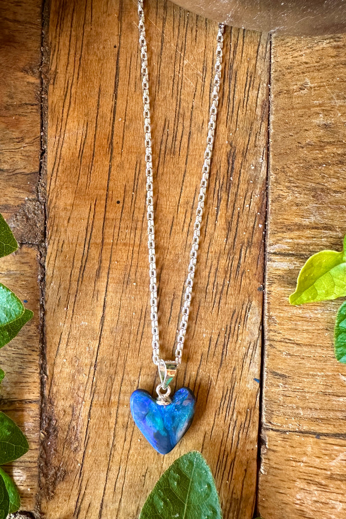 This Australian black opal pendant has bright blue and teal swirls