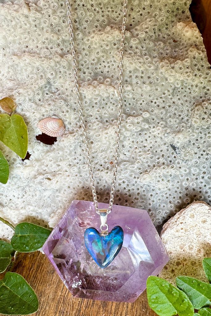 This Australian black opal pendant has bright blue and teal swirls