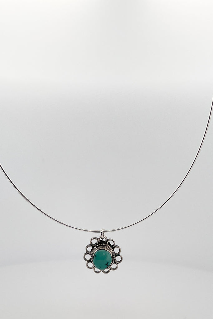 This lovely old turquoise pendant is a one off piece. Artisan set into unmarked silver, it is a flower shape, it hangs from a good 925 silver omega chain necklace. 