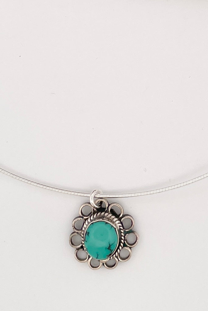 This lovely old turquoise pendant is a one off piece. Artisan set into unmarked silver, it is a flower shape, it hangs from a good 925 silver omega chain necklace. 