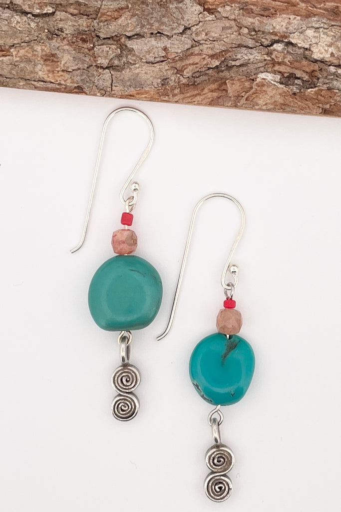 These simple handmade earrings have a strong desert vibe, the chunky natural turquoise bead is the centrepiece, with natural faceted  sunstone, and a Thai silver swing drop.