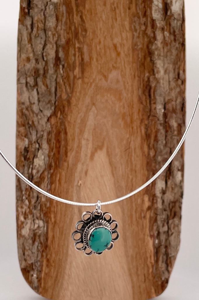 This lovely old turquoise pendant is a one off piece. Artisan set into unmarked silver, it is a flower shape, it hangs from a good 925 silver omega chain necklace. 