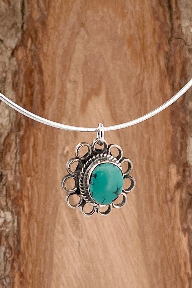 This lovely old turquoise pendant is a one off piece. Artisan set into unmarked silver, it is a flower shape, it hangs from a good 925 silver omega chain necklace. 