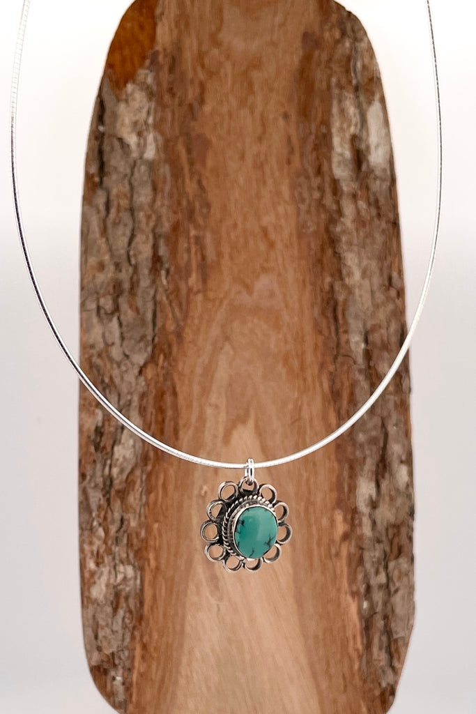 This lovely old turquoise pendant is a one off piece. Artisan set into unmarked silver, it is a flower shape, it hangs from a good 925 silver omega chain necklace. 