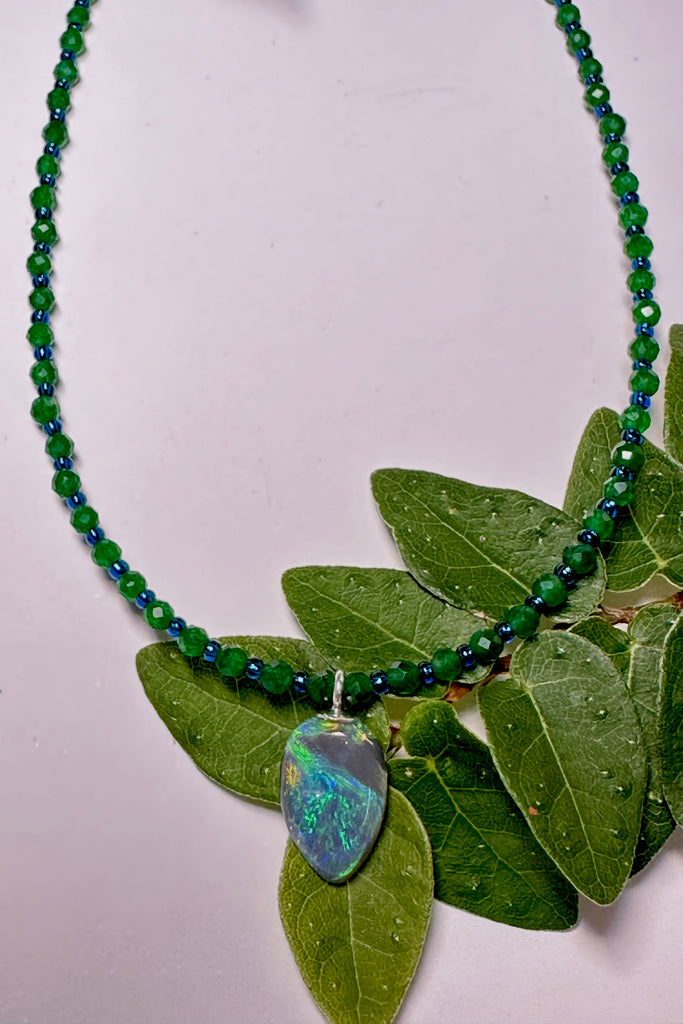 tiny, delicate and pretty opal pendant, it has bright blue and green dancing across the stone, on an emerald green quartz necklac