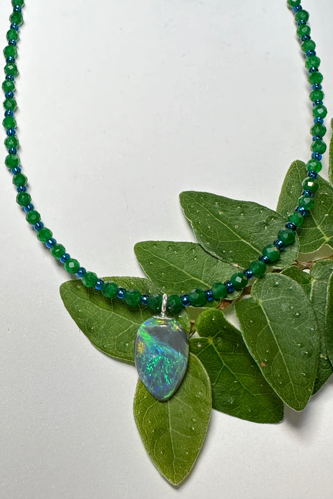 tiny, delicate and pretty opal pendant, it has bright blue and green dancing across the stone, on an emerald green quartz necklace