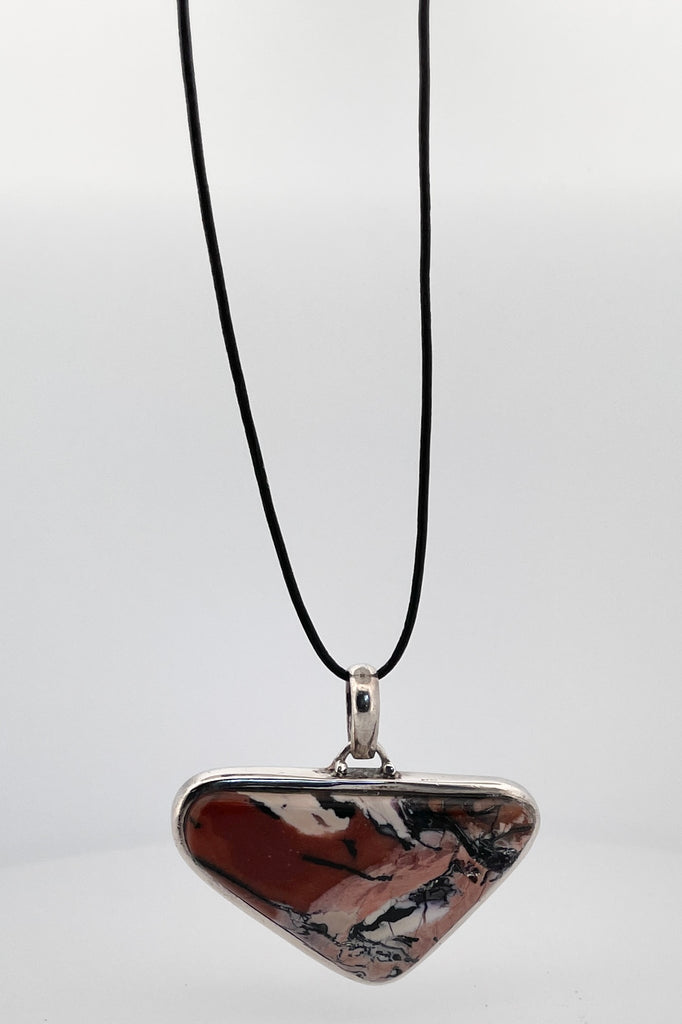 This unique pendant is a slice of natural Jasper stone, shaped and polished into a powerful pendant. Set in 925 silver. 