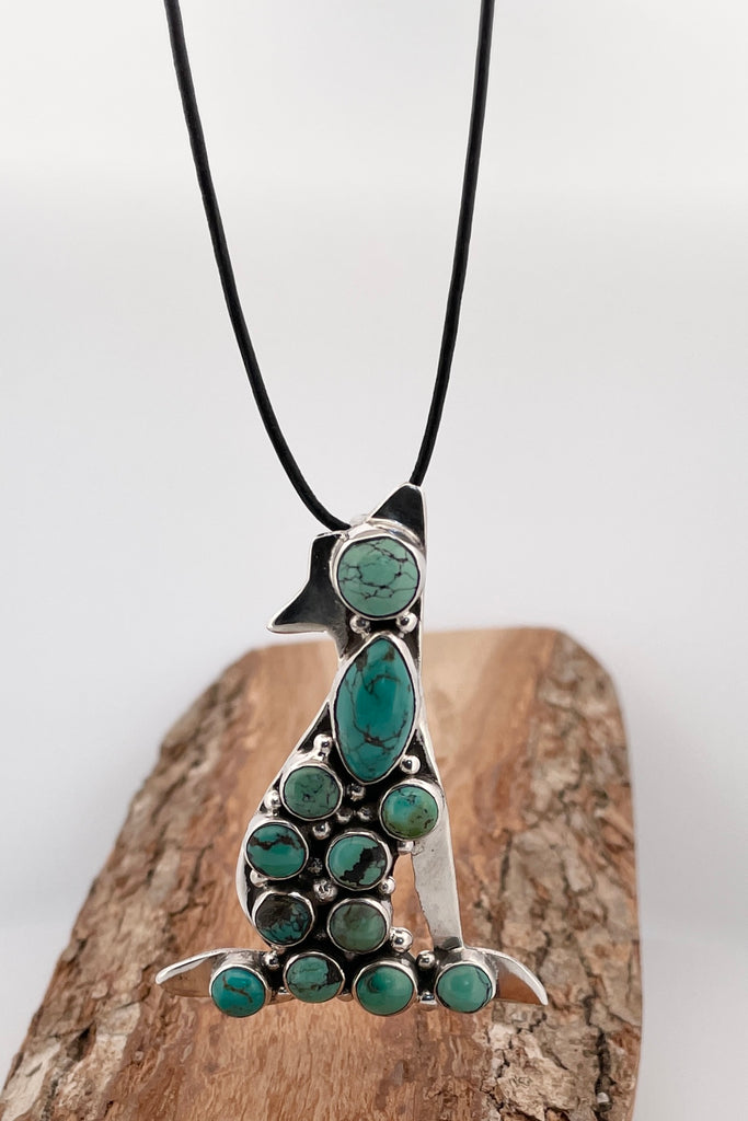 Vintage Coyote Brooch/pendant, the coyote dog has been set with twelve hand cut natural turquoise cabochons. This brooch has a wonderful power, it seems to carry the spirit of the maker. Made and marked in 925 silver