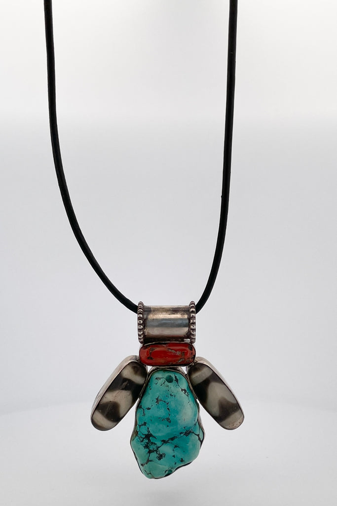 This curious piece has a wonderful mystical vibe, the large centre piece is an old turquoise bead, on each side is an agate dzi bead on top is a piece of old Tibetan red coral.
