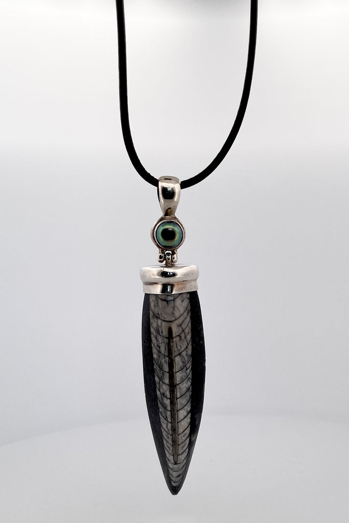 Ancient Trilobite fossil pendant. The ancient world on a necklace, a polished trilobite pendant about 100 million years old. Set in silver it has a pearl at the top, the bail is articulated. 