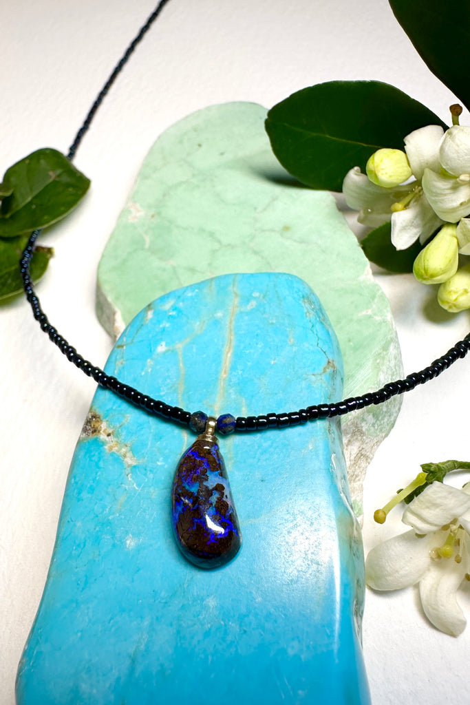 Such chic take on an opal necklace, a perfectly shaped swoop, this opal pendant has deep bright blue crystal mixed with the dark boulder, its organic and minimalist.
