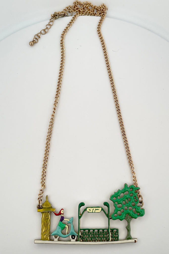 A chic little French girl riding a scooter, this is a necklace from the early 2000's, so not new, but in good condition.