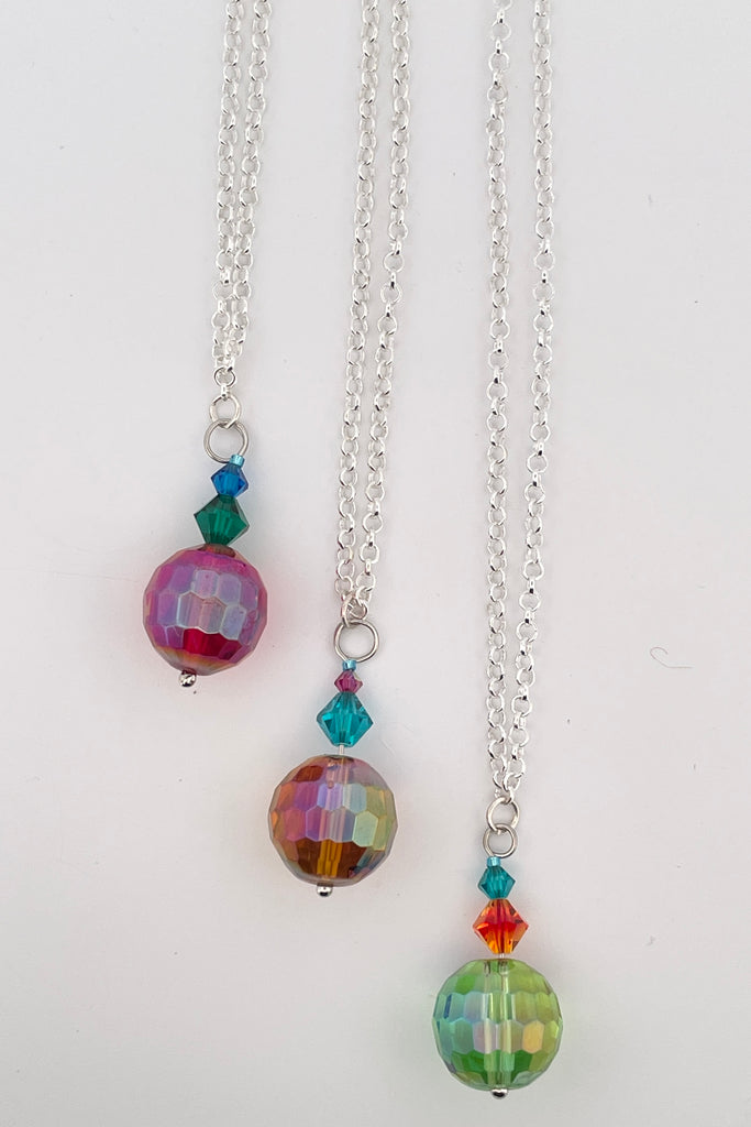 Eye catching colourful crystal beads hung from a silvery bail. 